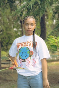 a woman wearing a t - shirt with a smiley face