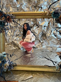 a woman is sitting in a frame with tin foil