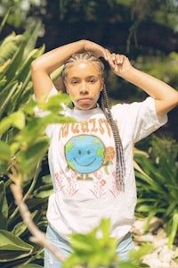 a woman wearing a t - shirt with the word earth on it